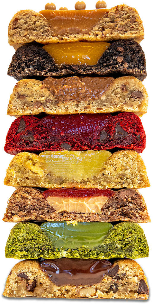 Stack of assorted flavored bar cookies with various fillings, including chocolate, nut, and fruit.