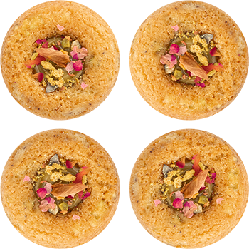 Four round sponge cakes with edible flower and leaf toppings on a patterned background are featured prominently on "Homepage 001".
