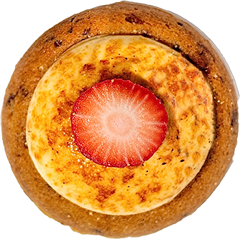 A close-up view of a creme brulee tart topped with a fresh strawberry slice on Homepage 001.